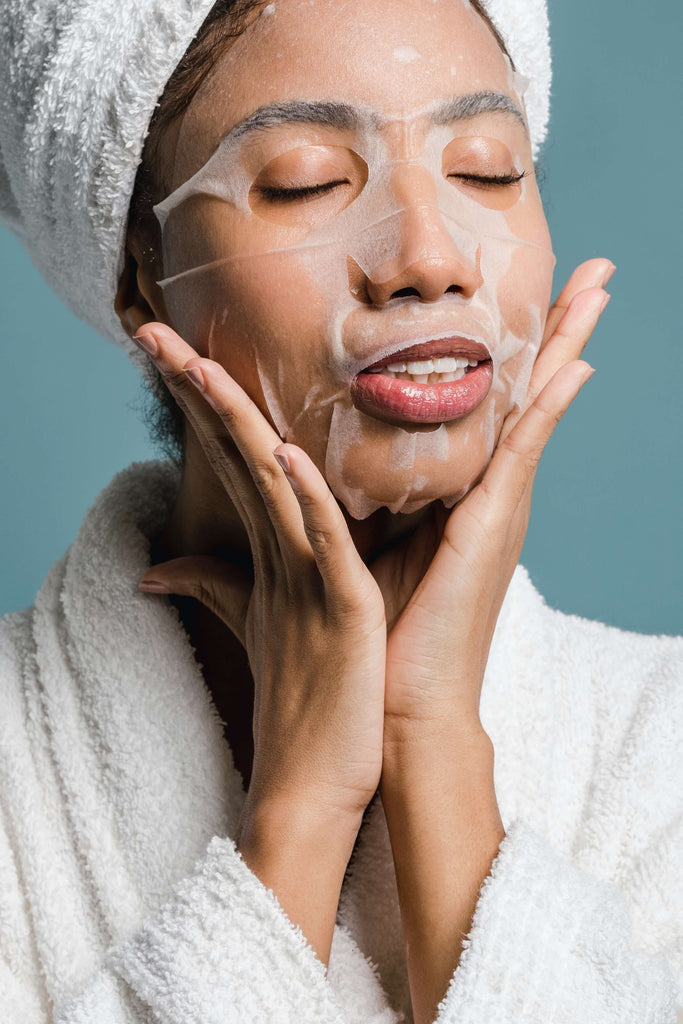 Woman relaxing with sheet mask on face