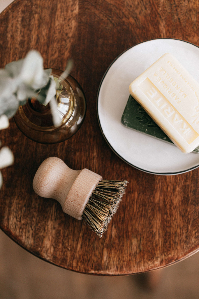 Natural beauty products including soap, try brush, and eucalyptus